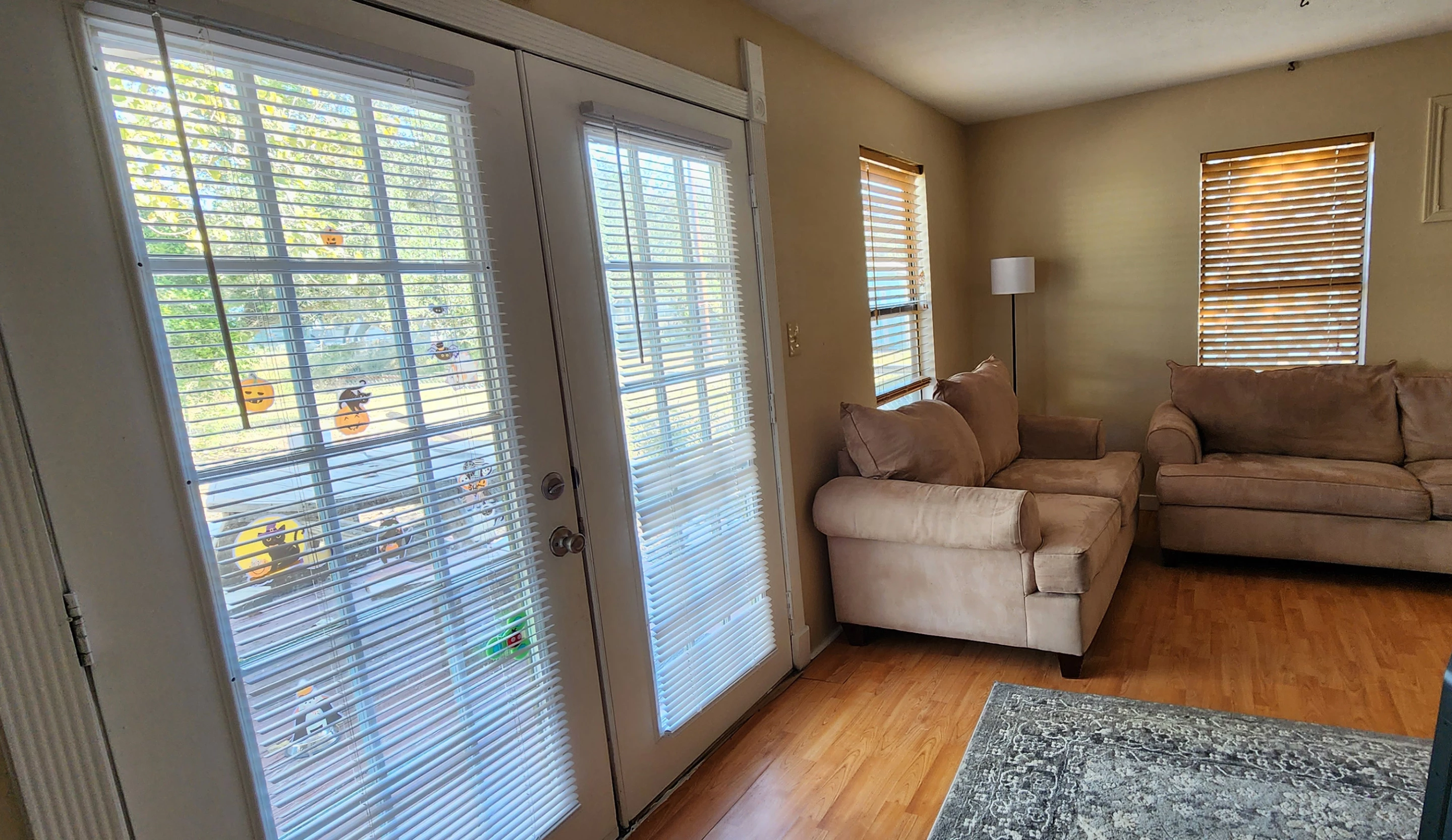I have a weird, long living room. This is what it looked like before I installed the shades