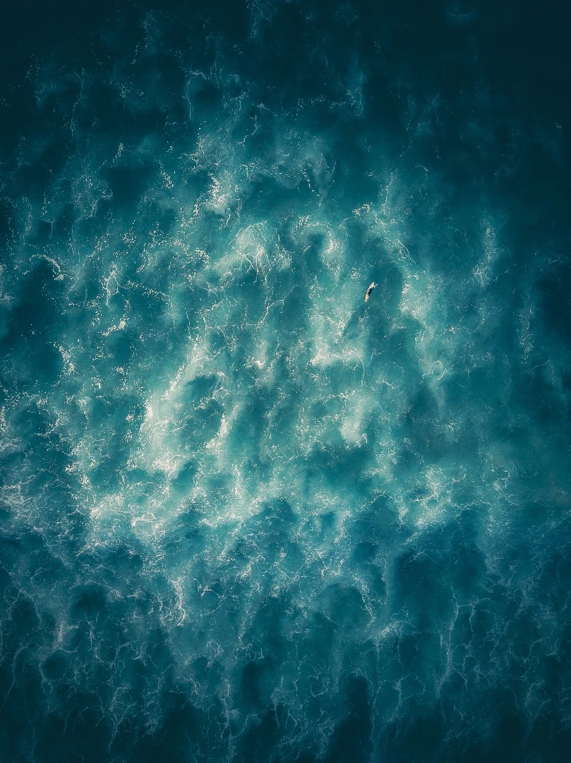 A lonely surfer battles his way to the next wave