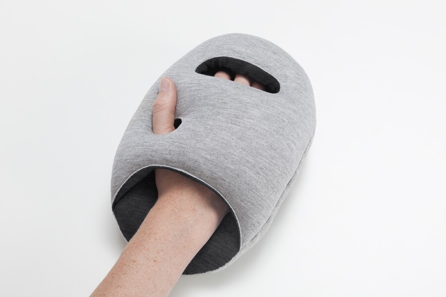 The Ostrich Pillow Mini has hand and thumb holes so it can be worn on the hand