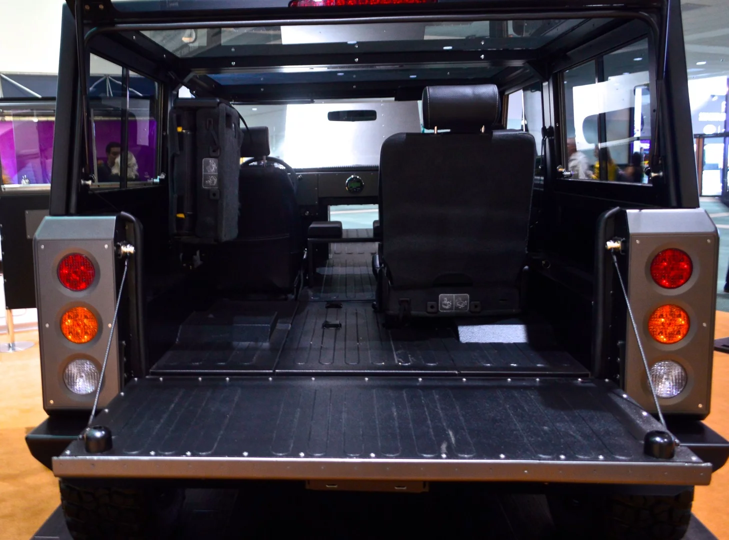 Thanks to its flat floor and pass-through design, the Bollinger B1 electric utility vehicle offers plenty of room for lumber and other long items