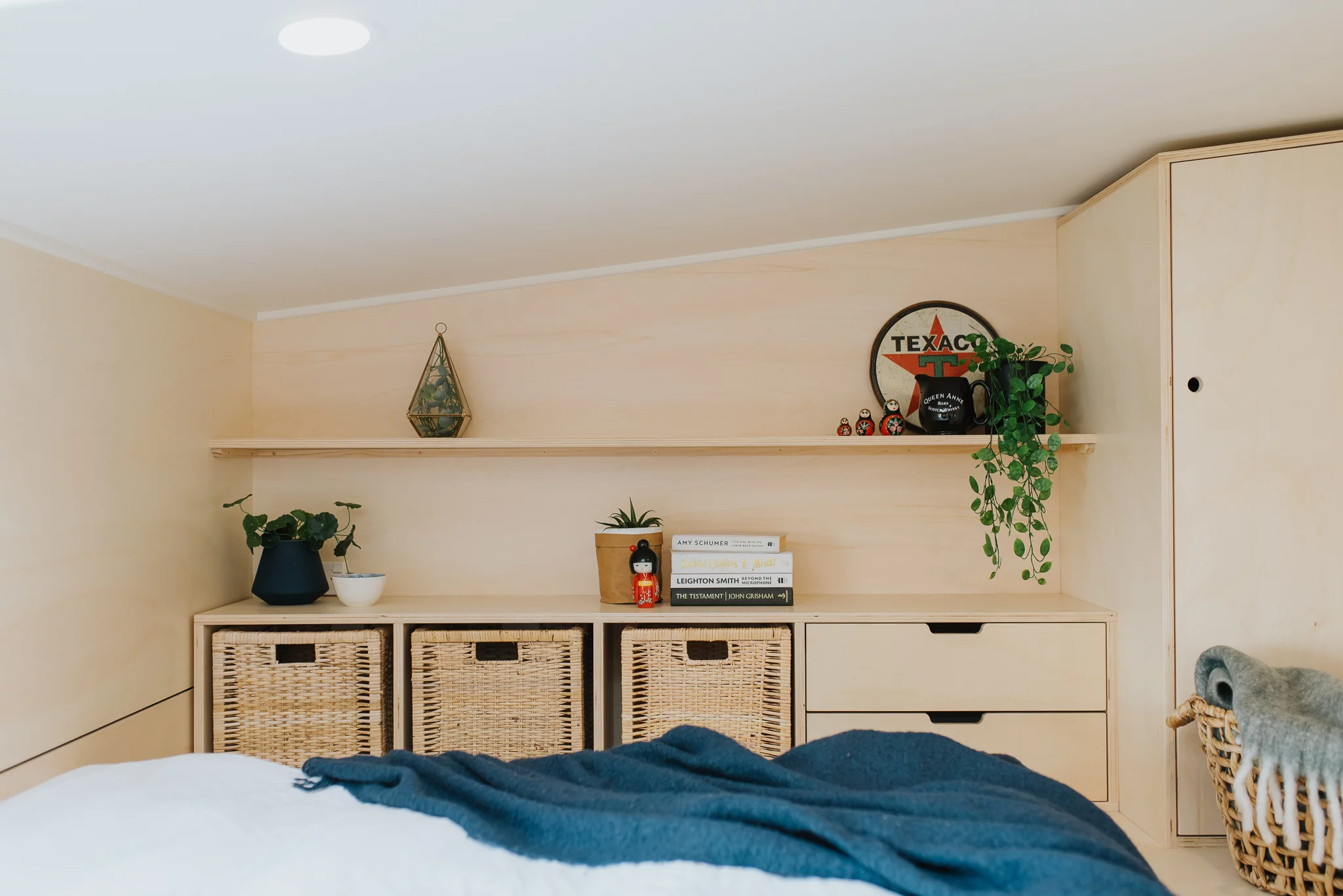 The Daisy Vera Tiny House's bedroom has some additional storage space for clothes and books