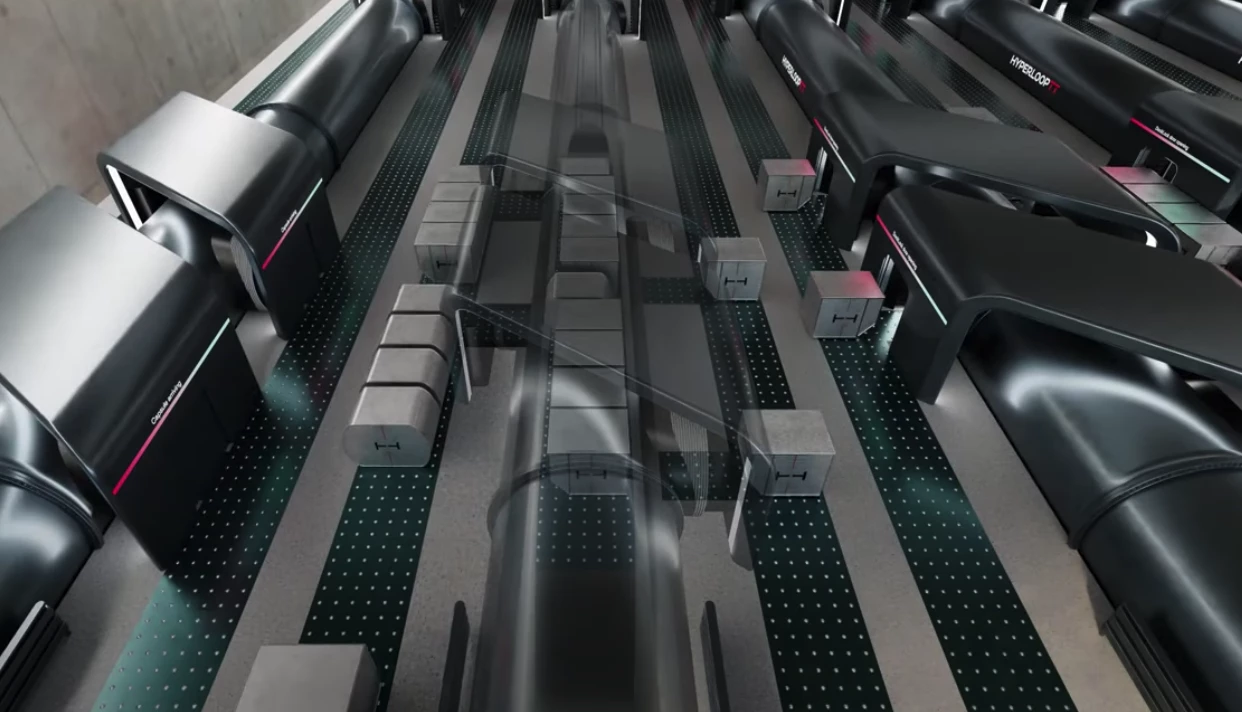 Staggered load and unload doors work with rollerball conveyors to automatically and simultaneously load and offload freight containers
