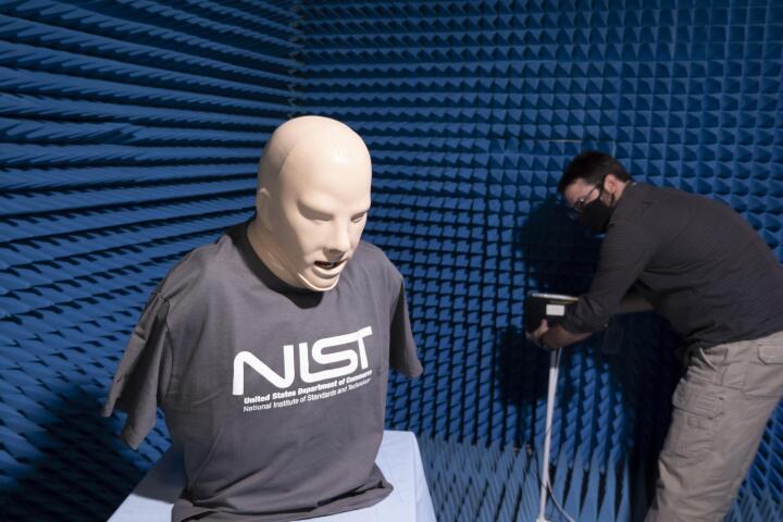 Medical dummy on table in room with researcher.