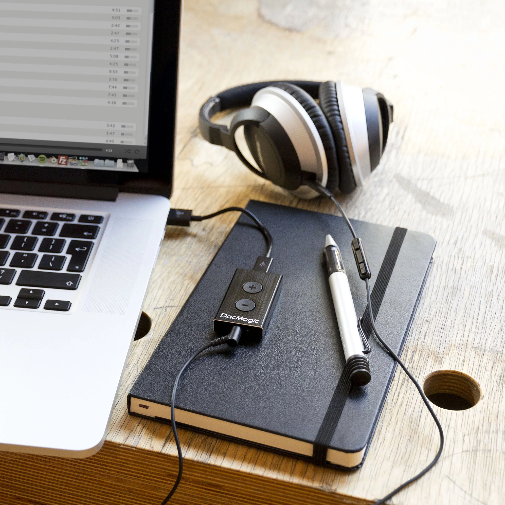 The DacMagic XS sits between a USB port on a computer or laptop and your headphones
