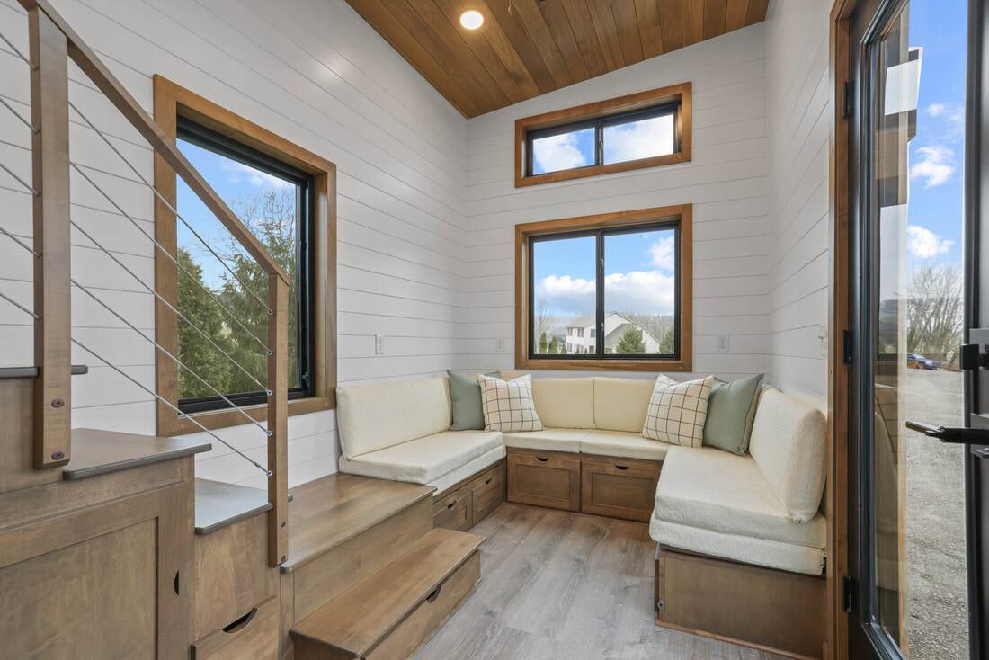 Visitors to the Coastal Modern enter into a living room with a U-shaped seating area