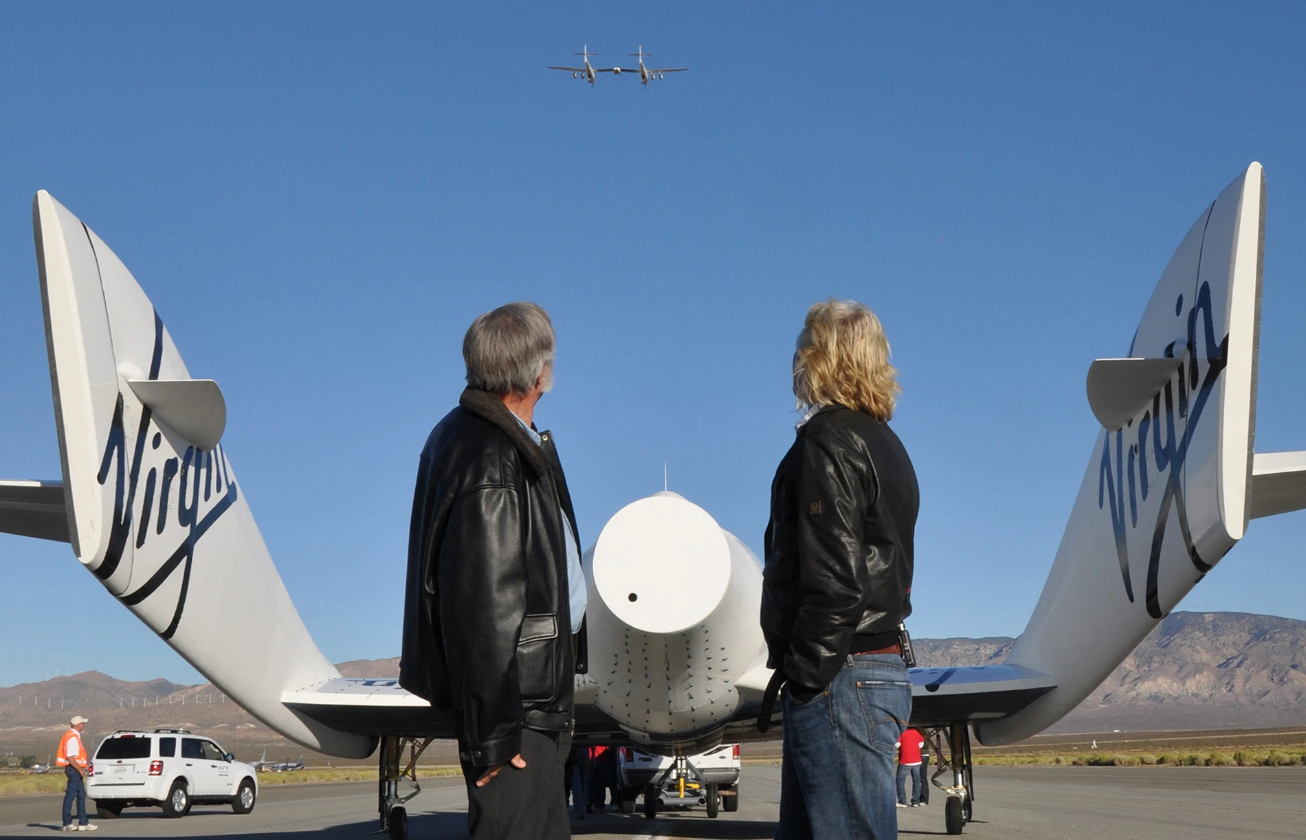 Sir Richard Branson and Burt Rutan with VSS Enterprise as VMS Eve flies above (Image: Mike Mills)
