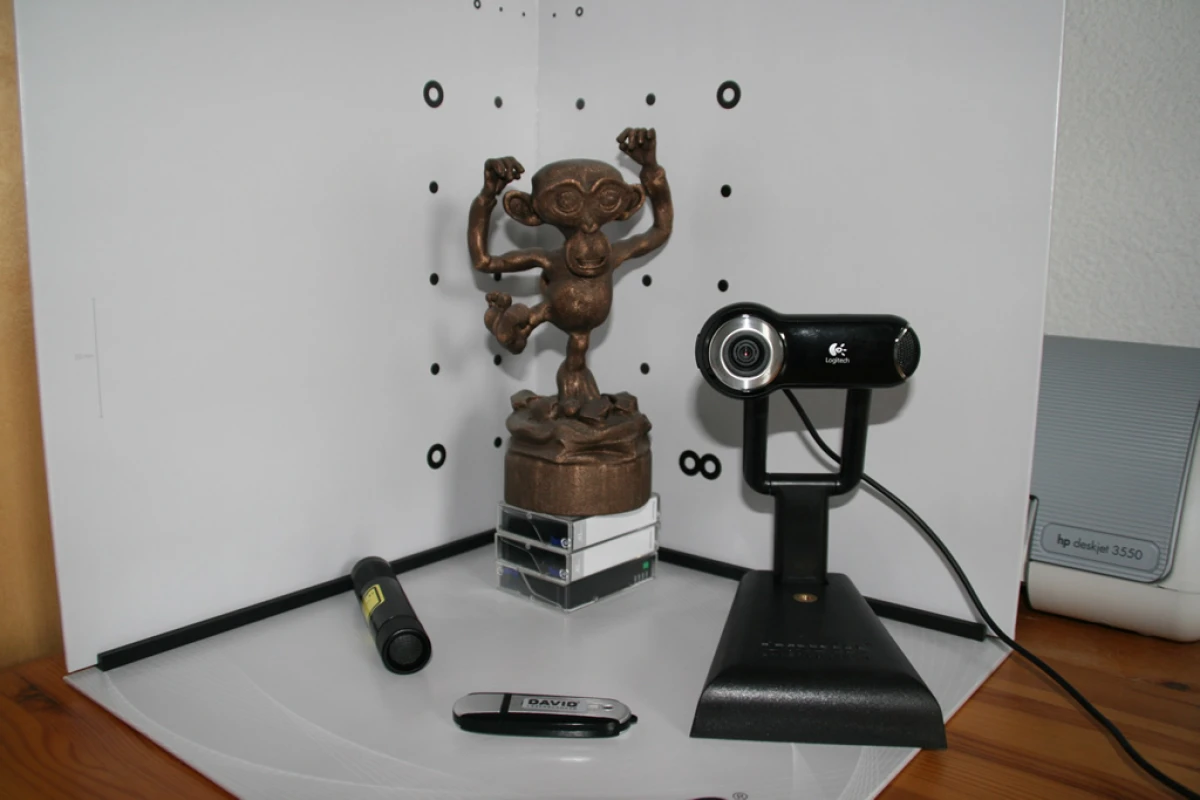 Low-cost 3D-scanning using gray scale camera, laser pen and calibration points