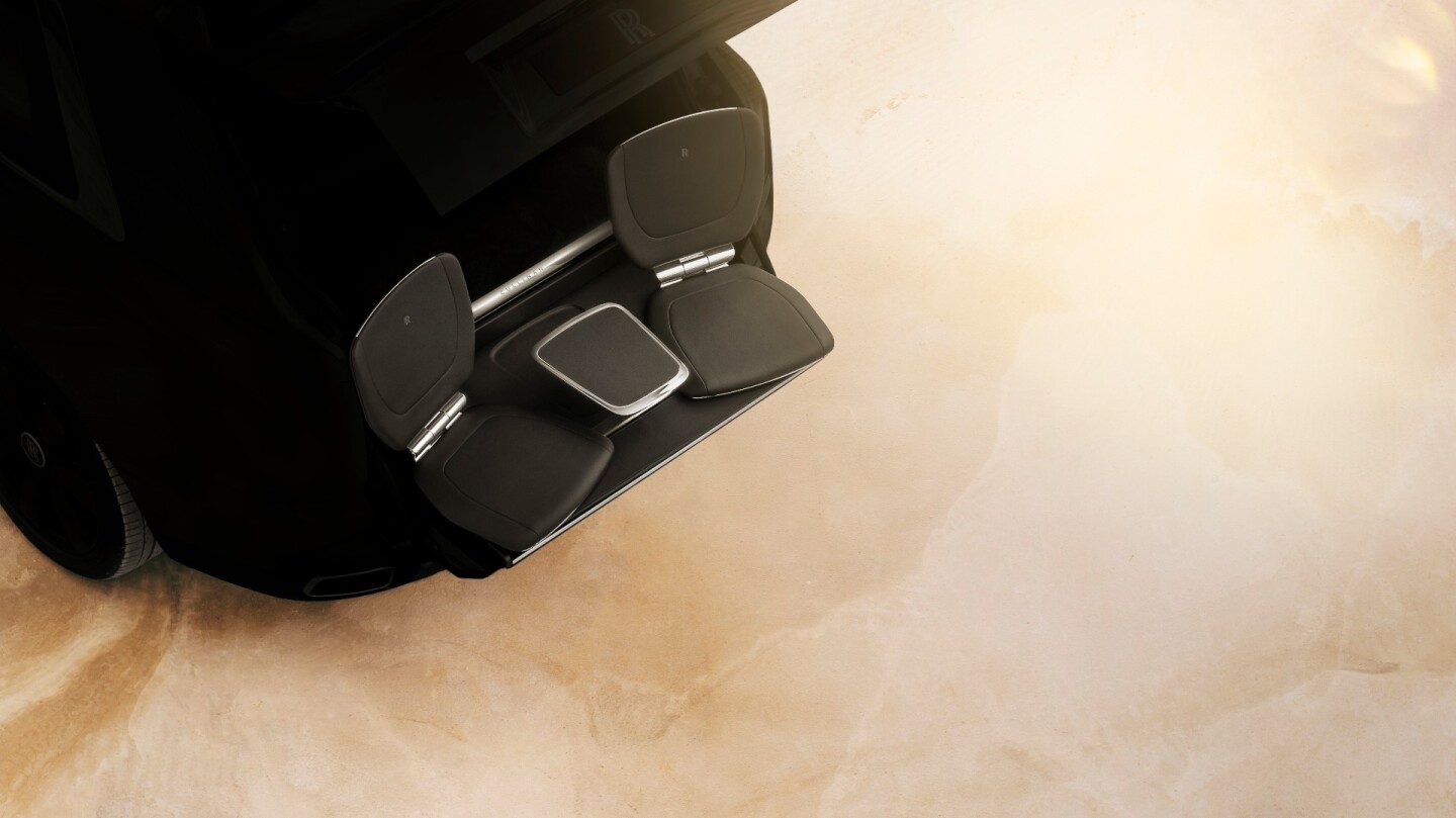 The seating group slides out of a compartment in the trunk floor and pops up out back