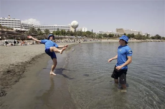 Subaru's Atkinson and Solberg relax on the beach before the event