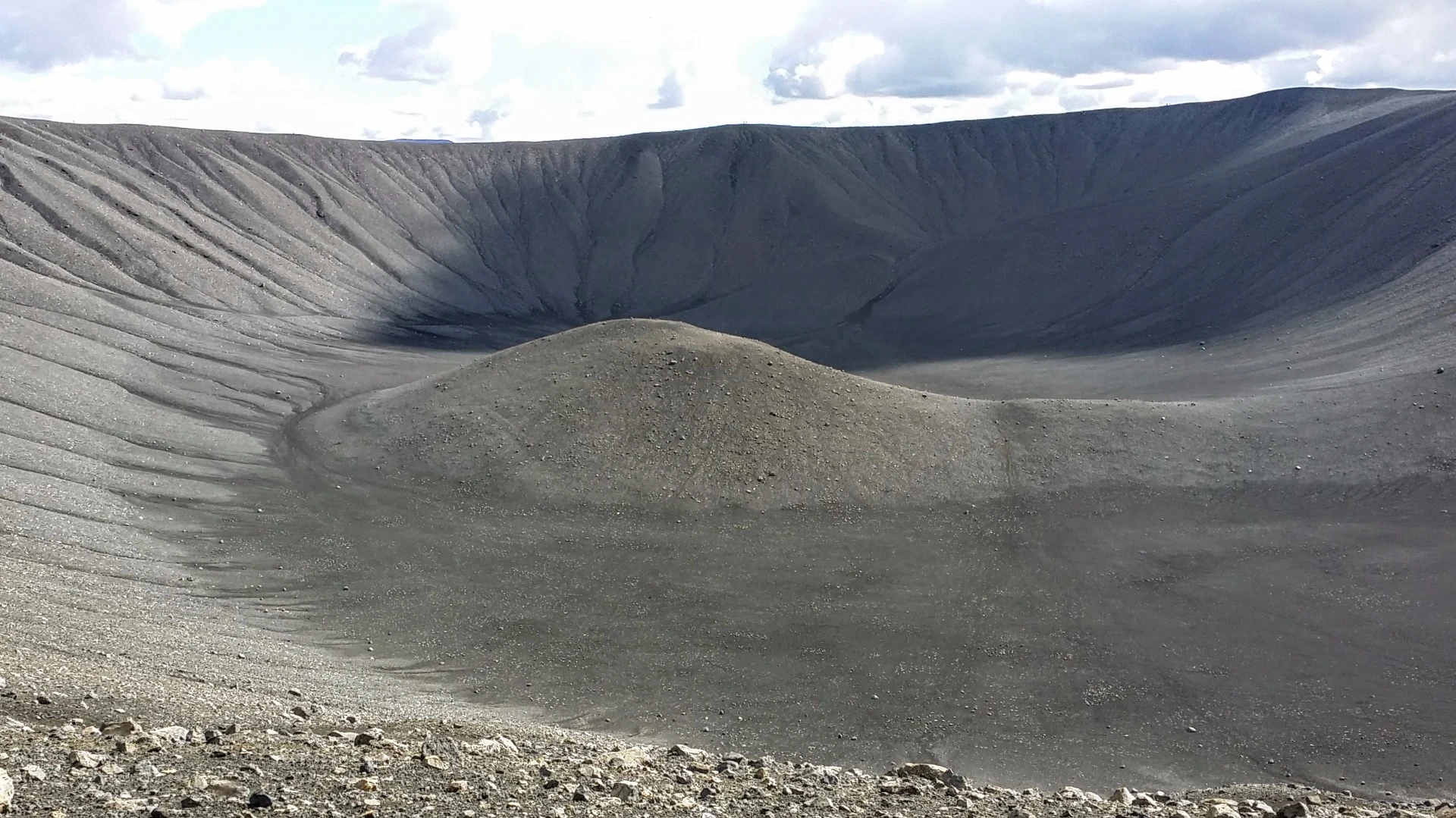 Dominating the view from much of the area around Lake Myvatn is this lunar-like landscape, the Hverfell crater. Hverfell (or Hverfjall as it's sometimes called) is what's left behind after a volcano exploded about 3,000 years ago. The crater measures about 140 meters (460 ft) deep and has a diameter of approximately 1,000 meters (3,300 ft). It's known as a tephra cone, which refers to the hard ashy material that makes up its surface.