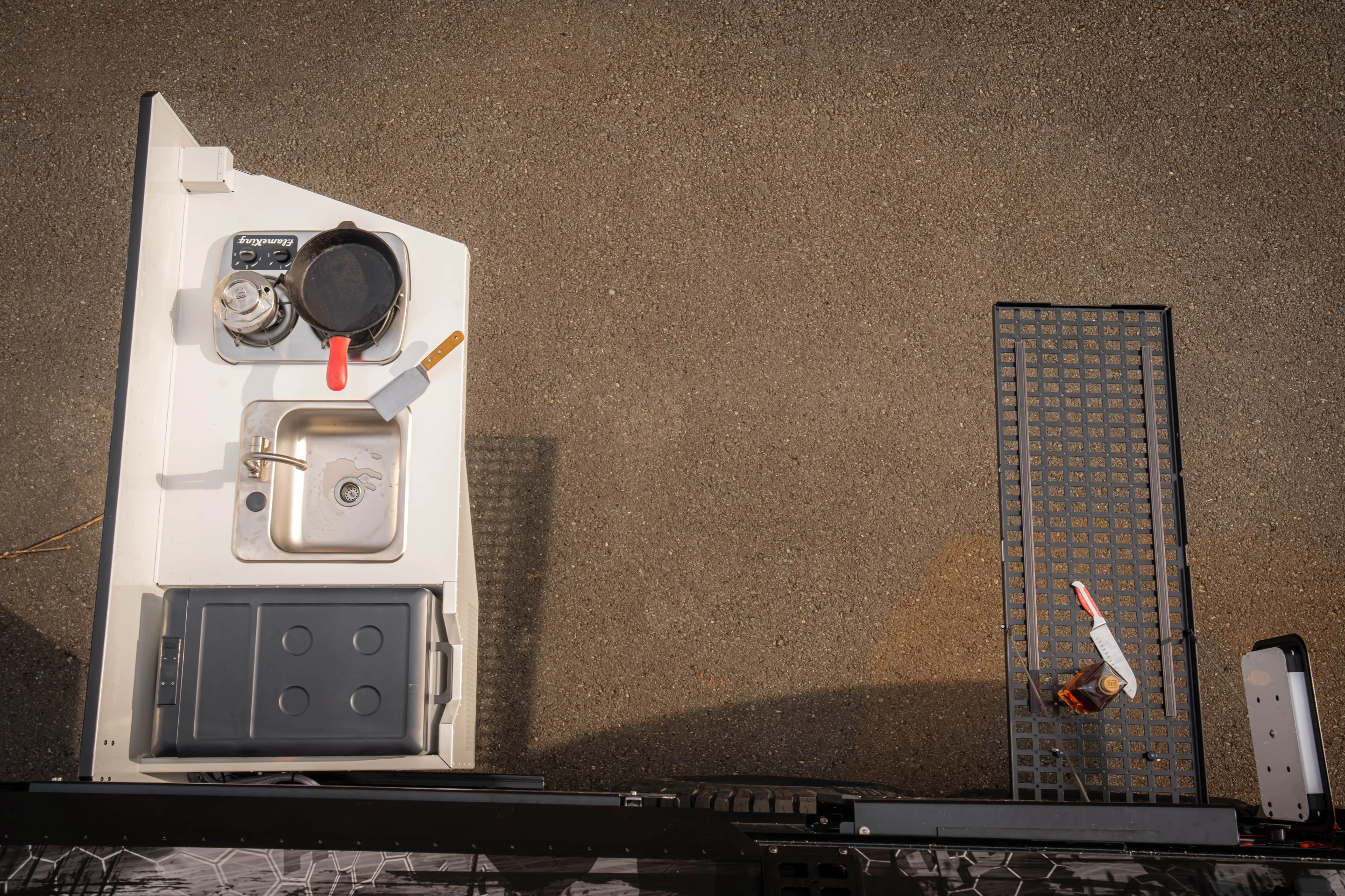 The outdoor kitchen doesn't have much work space, but the tall drop-down MOLLE table sure does