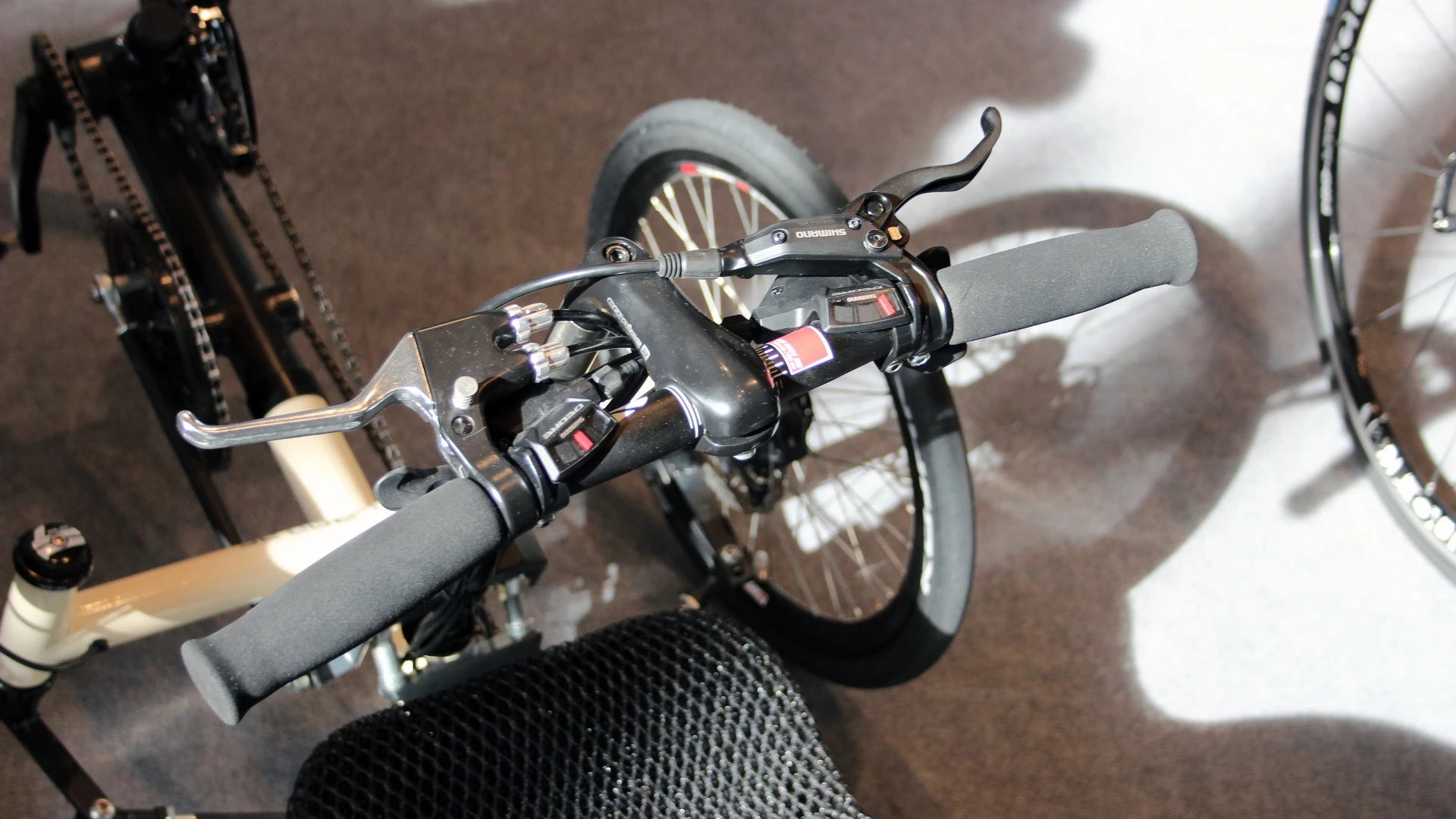 Instead of the circular arm-cranking motion used on the Varibike, the Ruder Trike has its user "rowing" the handlebar column in and out