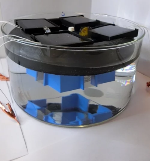 A photo of the prototype device, using a container of sulfuric acid as an electrolyte instead of seawater