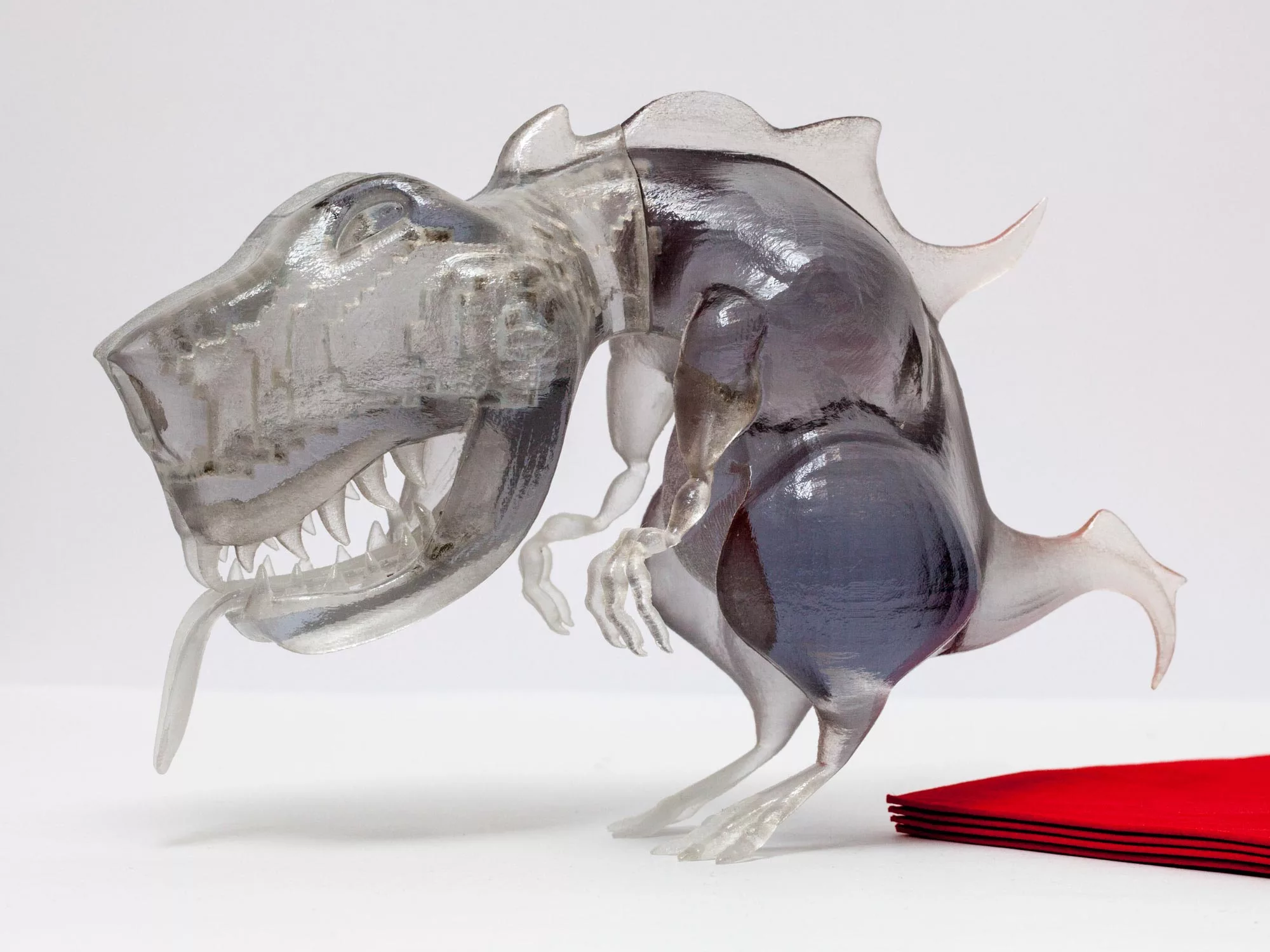 A translucent 3D printed T-Rex model shows the voxel void inside its head and neck generated by Make It Stand