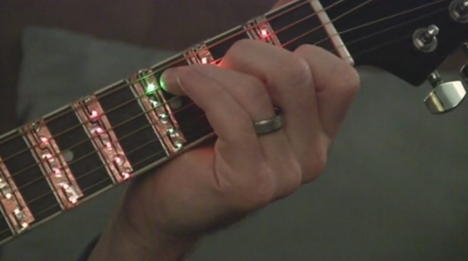 When an open string needs picking, all of LED lights along the appropriate string are dimly lit