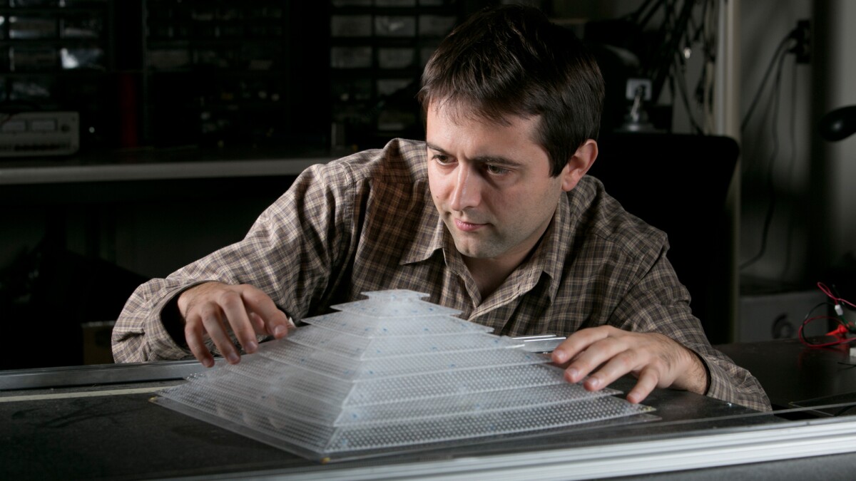 Research scientist Bogdan Popa with a 3D acoustic cloaking device constructed with components created in a 3-D printer (Photo: Duke Photography)