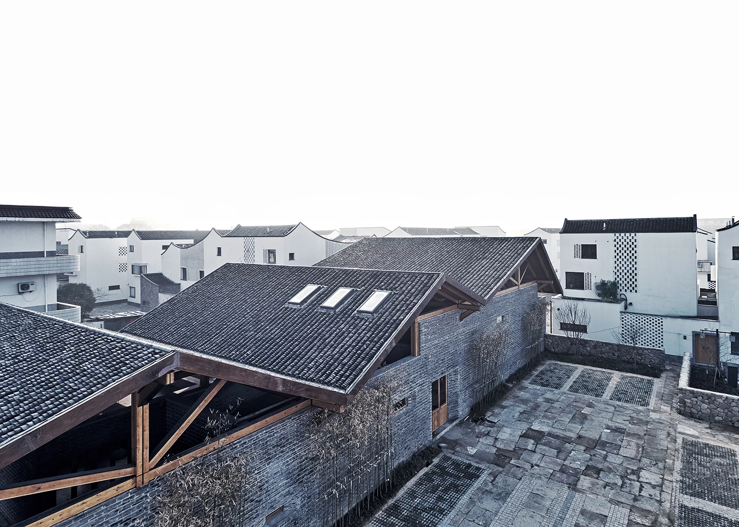 Dongziguan Villagers' Activity Center was designed by gad line+ studio and is located in China. It serves as a new housing project in the heart of the community that draws on traditional Chinese architecture