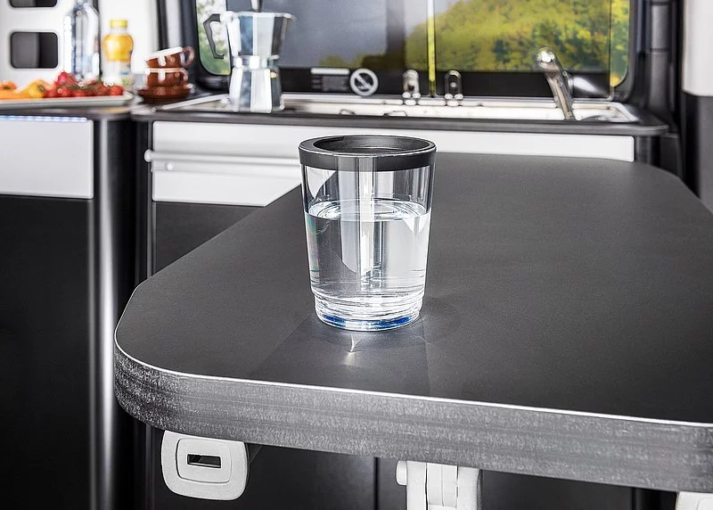 A simple but smart addition: The metallic table works with accompanying magnetic glasses to keep drinks more stable