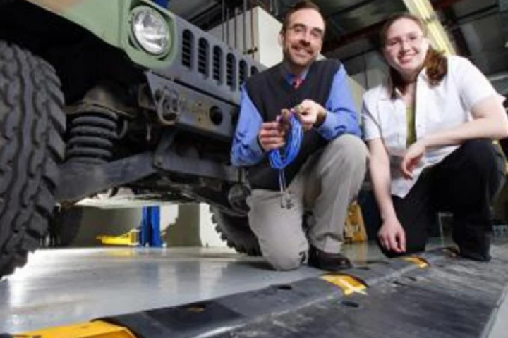 Purdue associate professor of mechanical engineering, Douglas Adams, and graduate student Tiffany DiPetta with the speed bumplike "diagnostic cleat"Pic credit: Purdue News Service photo/Andrew Hancock