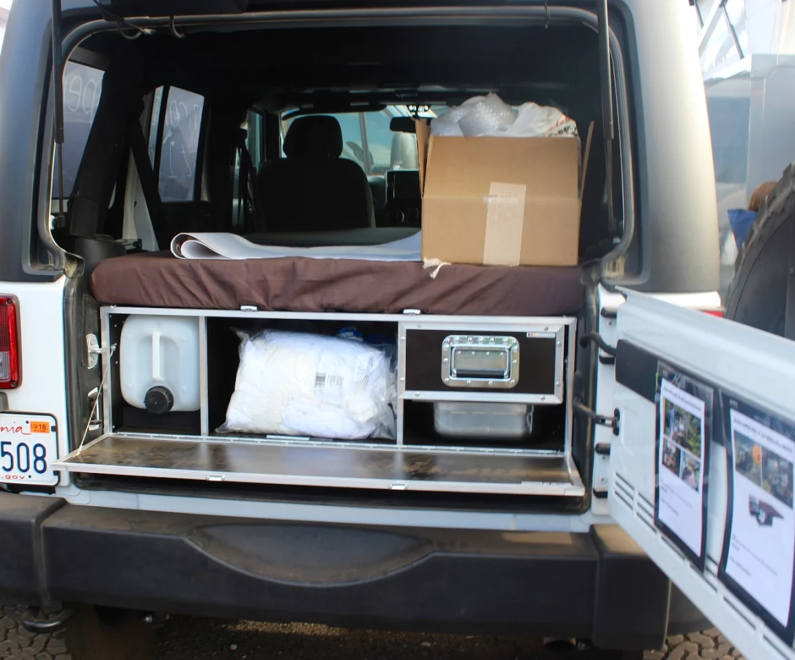 Ququq is making the trip to the US, from Germany. One of the products it's experimenting with is a Jeep Wrangler-based in-vehicle camper box to complement its G-Class and Defender kits