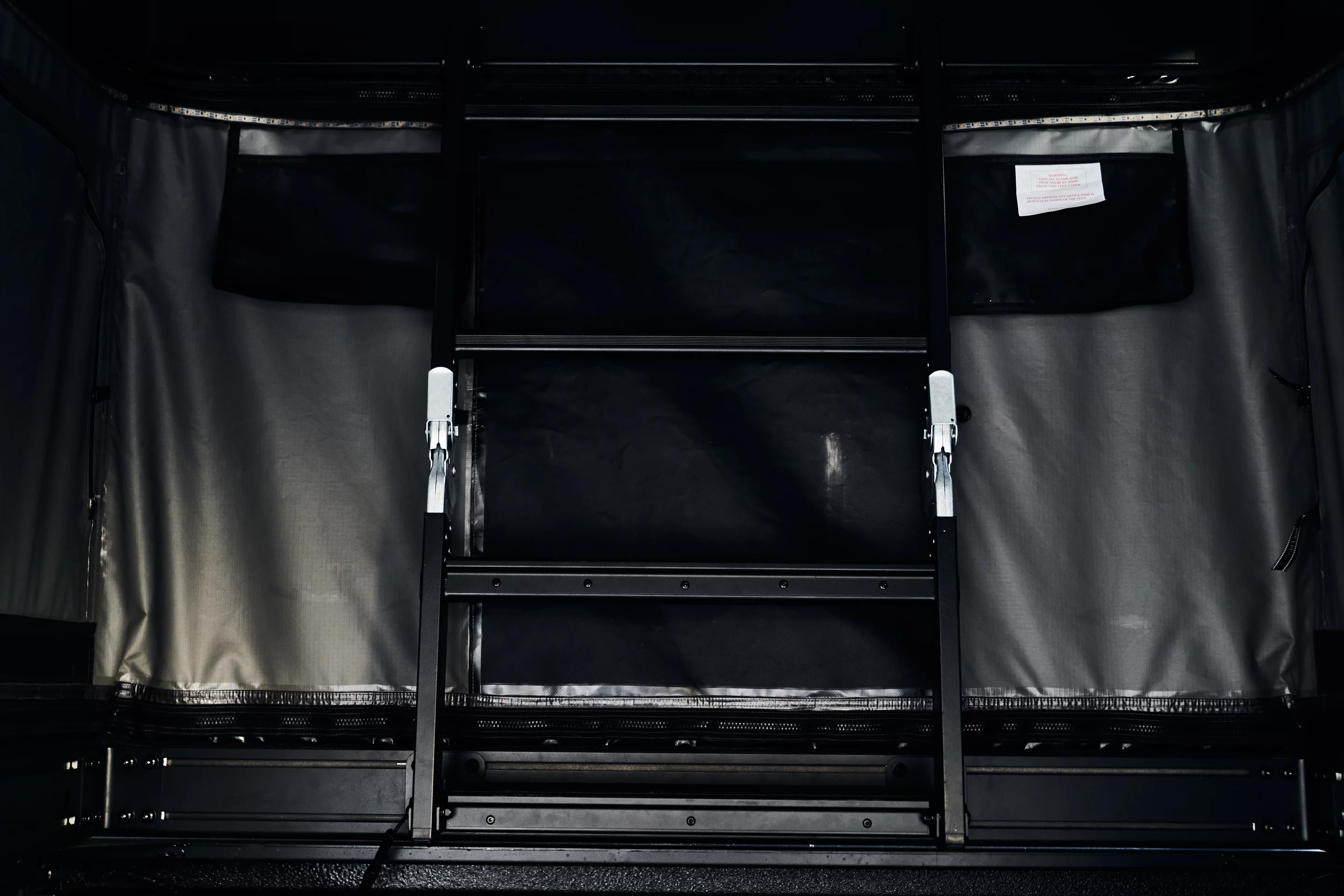 An interior ladder provides access from pickup bed to rooftop tent bed