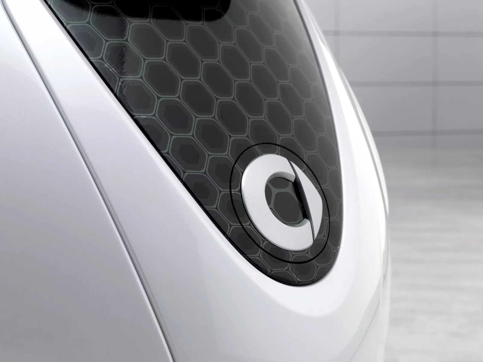 The hinged smart emblem hiding the charging socket
