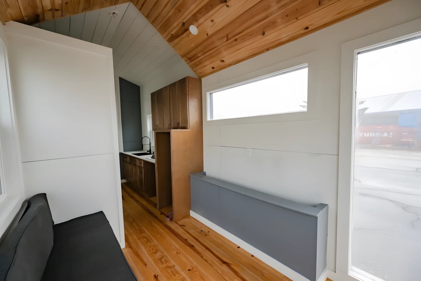 The living room includes a custom sofa and an entertainment center