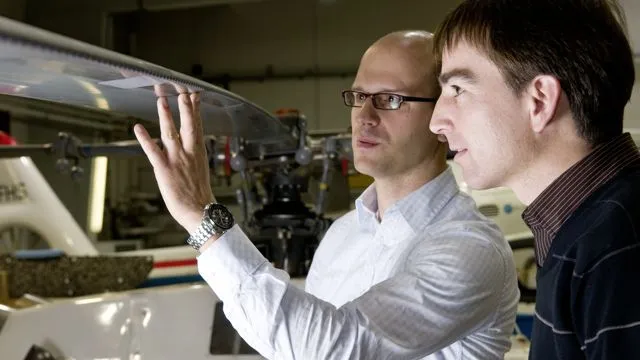 Kai Richter (left) and Holger Mai of DLR inspect the installation of humpback whale-inspired "LEVoGs" on the test helicopter