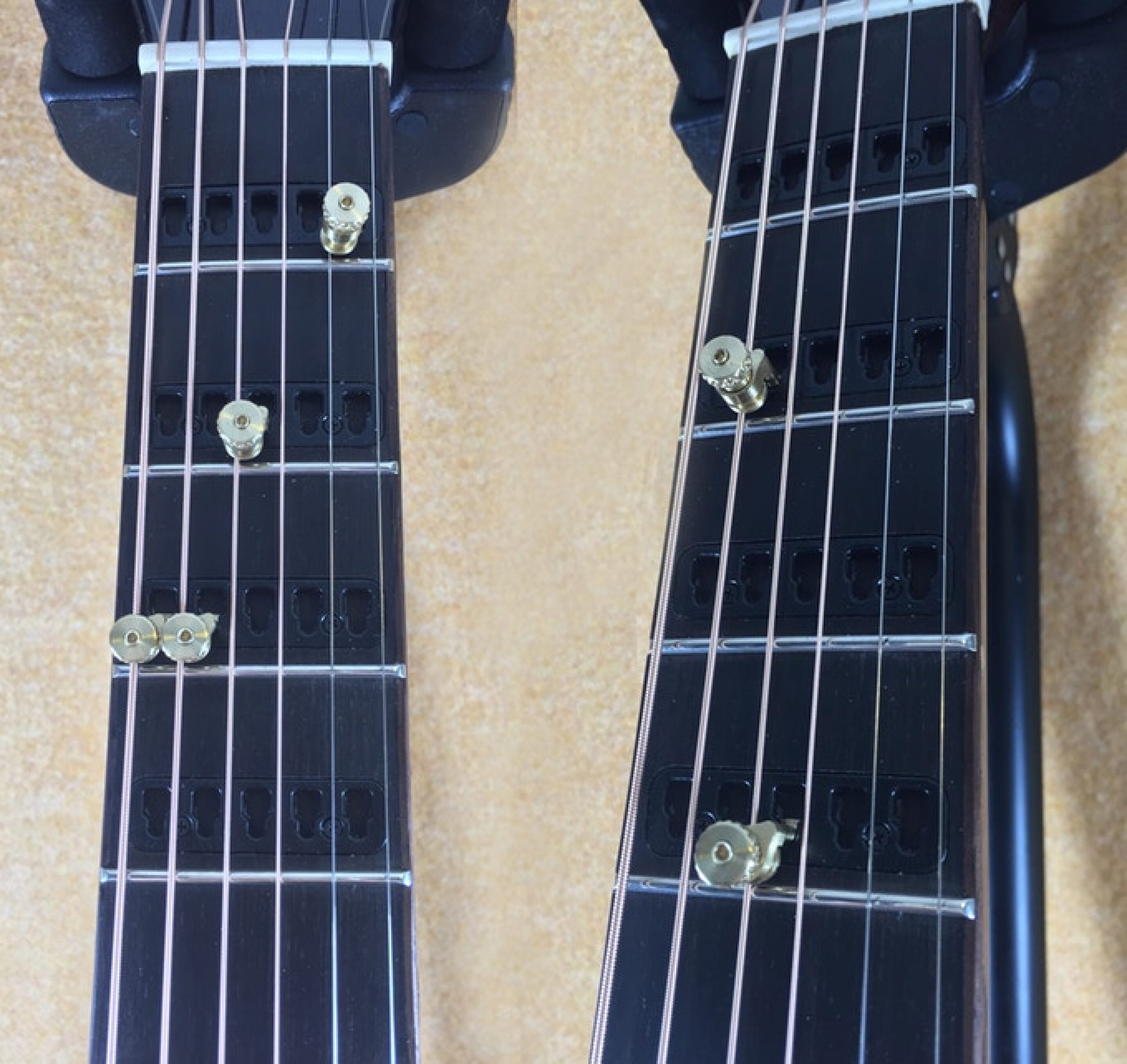 Acoustic guitar lets you lock single string capos to the neck