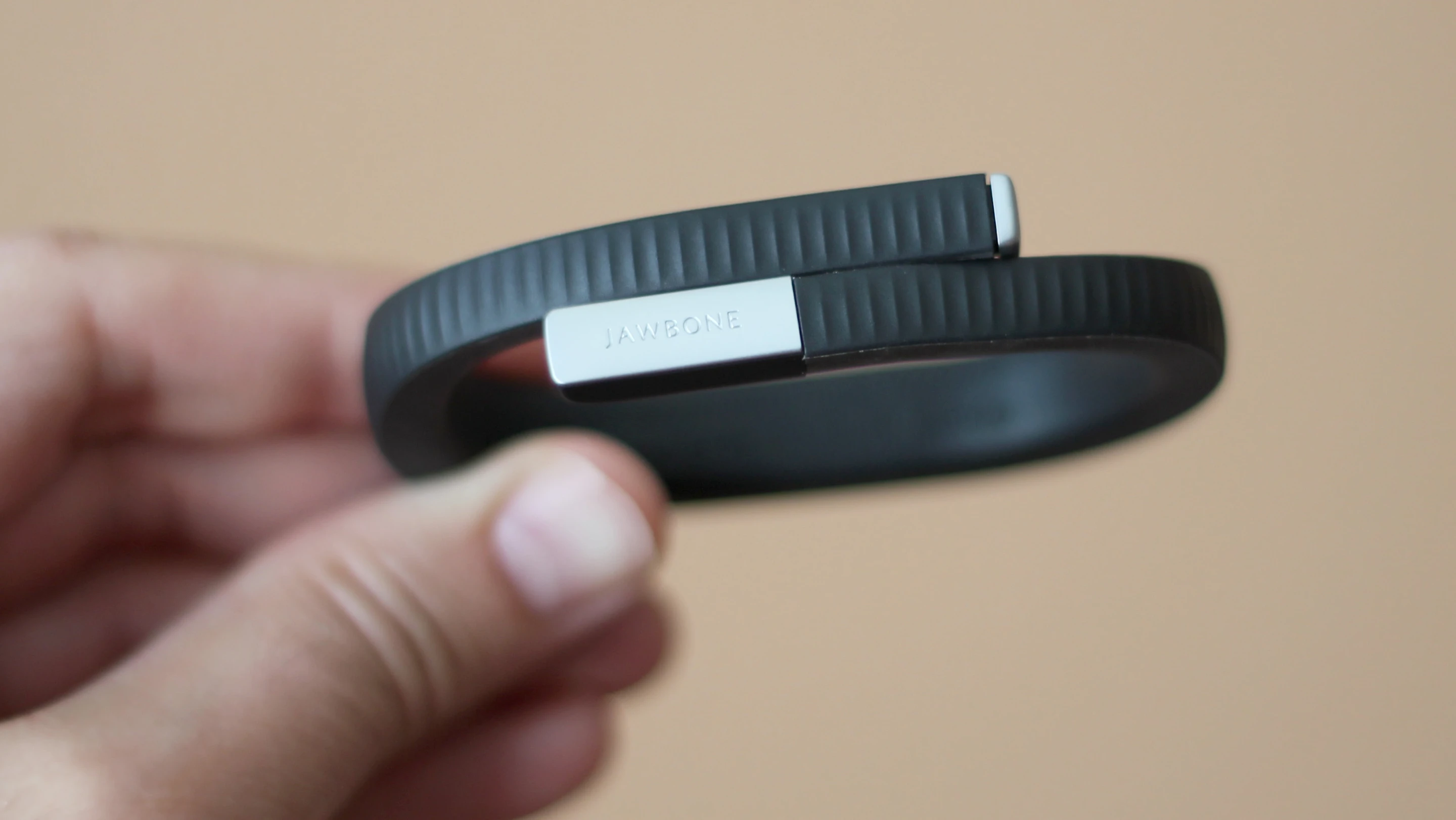 The wearable device has a rubbery feel with a ridged texture