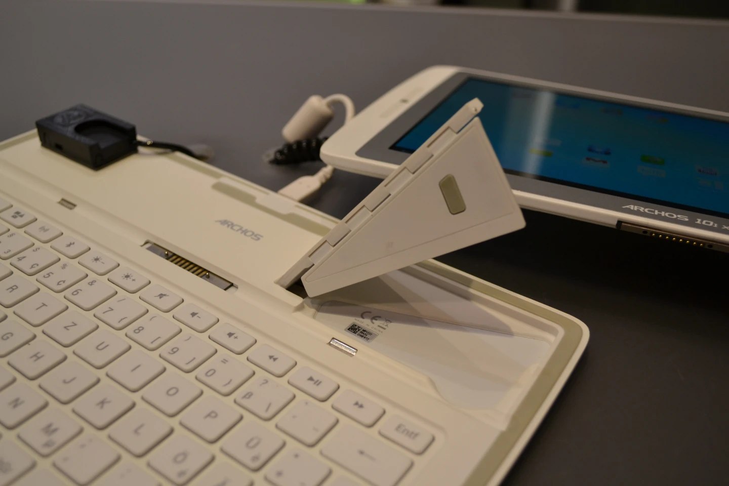 A hinged, magnetic kickstand attaches to the back of the body of the 101 XS to keep the Coverboard and tablet firmly together