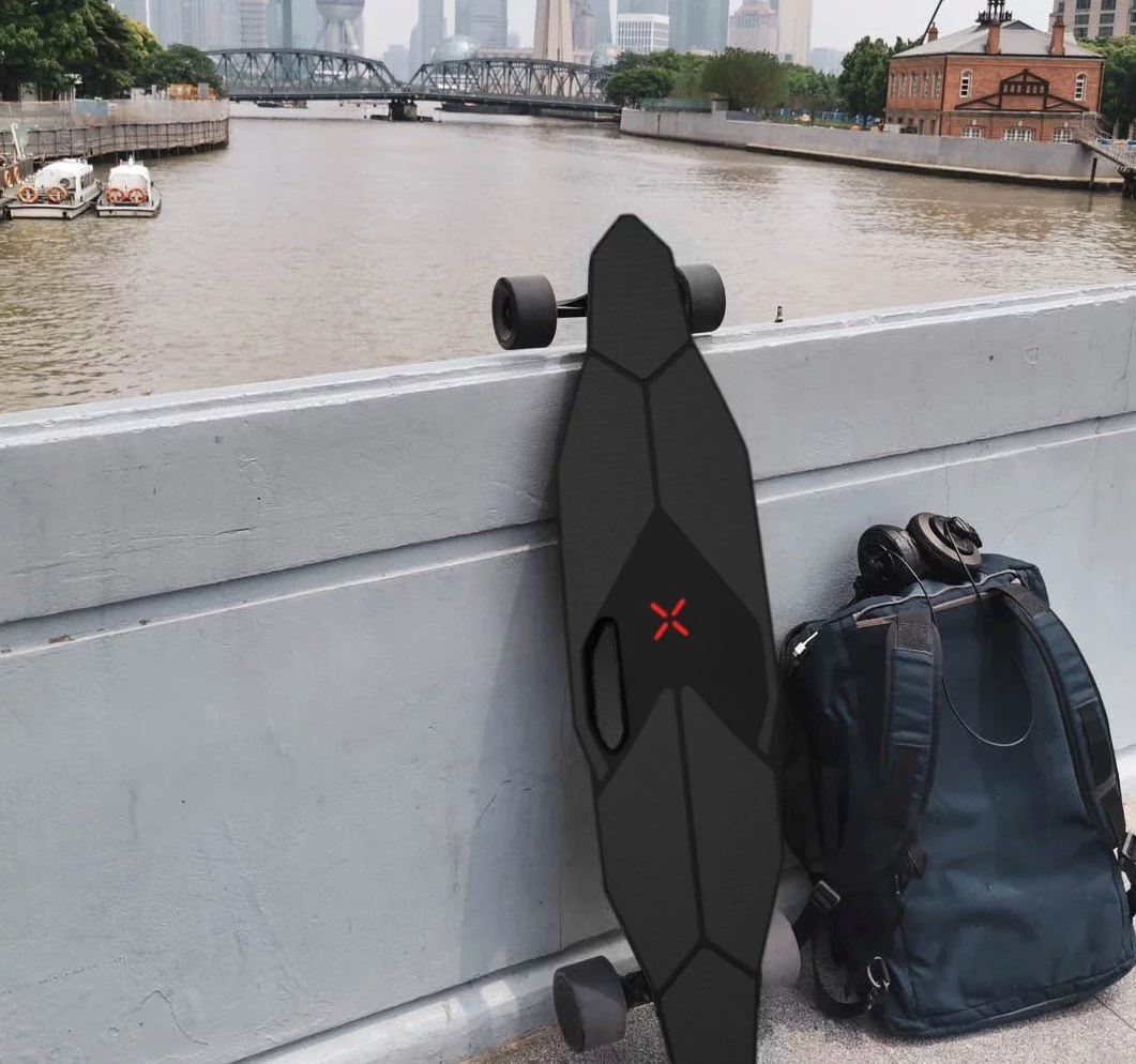 The M1 features a carry handle built into the longboard-like deck