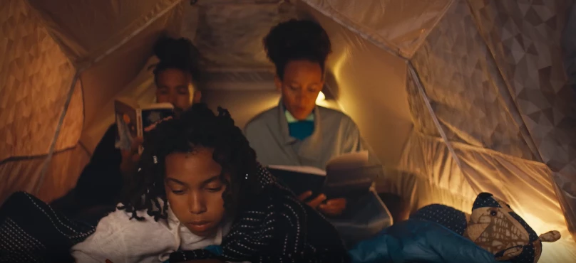 No official listing of the Basecamper's capacity, but the quick video suggests it's good for two adults or a family of three