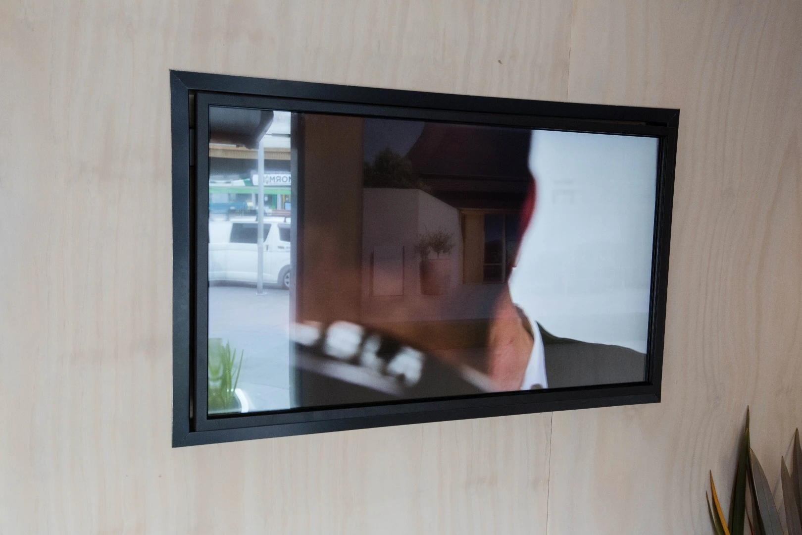A (slightly glary) television on the wall of the Tesla Tiny House