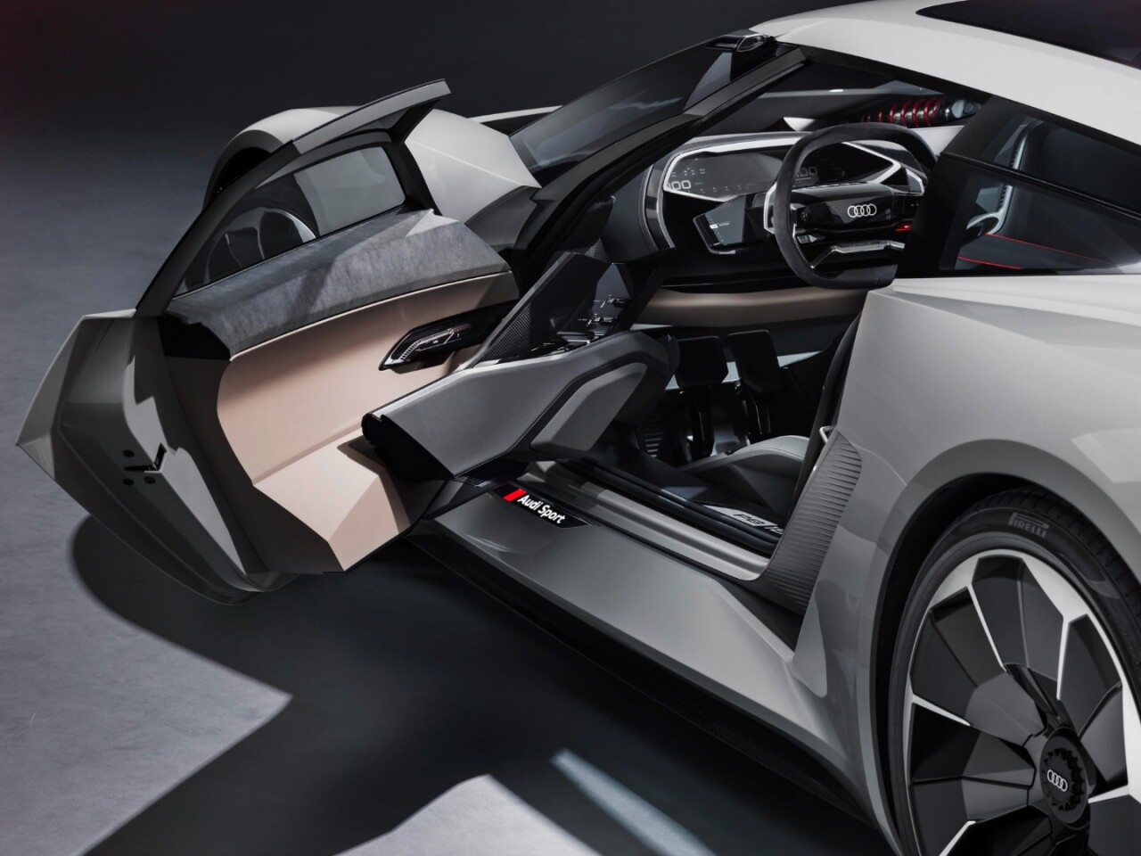 With the door open, the PB 18 e-tron's monocoque can be moved to different positions inside the car and it also reveals the unusual interior tech that's mounted in this Audi
