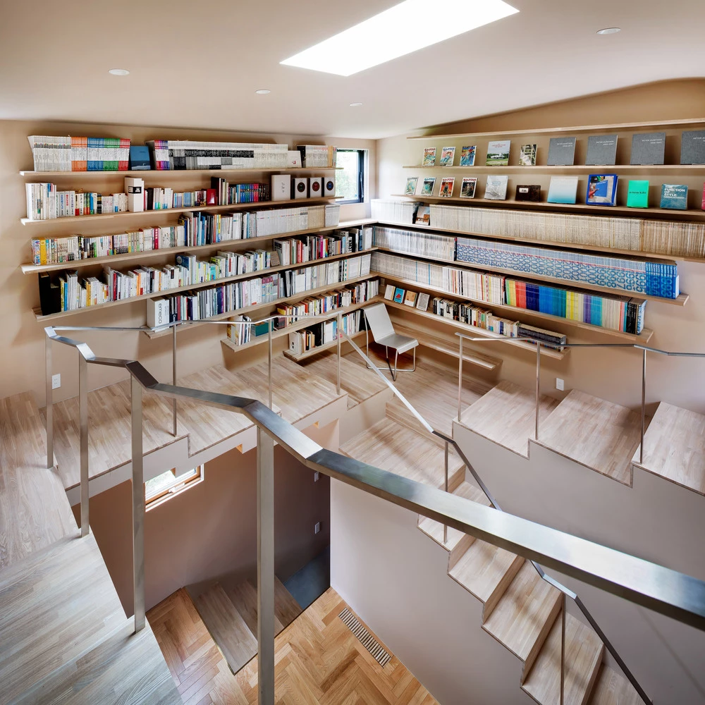 The central feature of the design is a spiral staircase that wraps around an atrium with a skylight