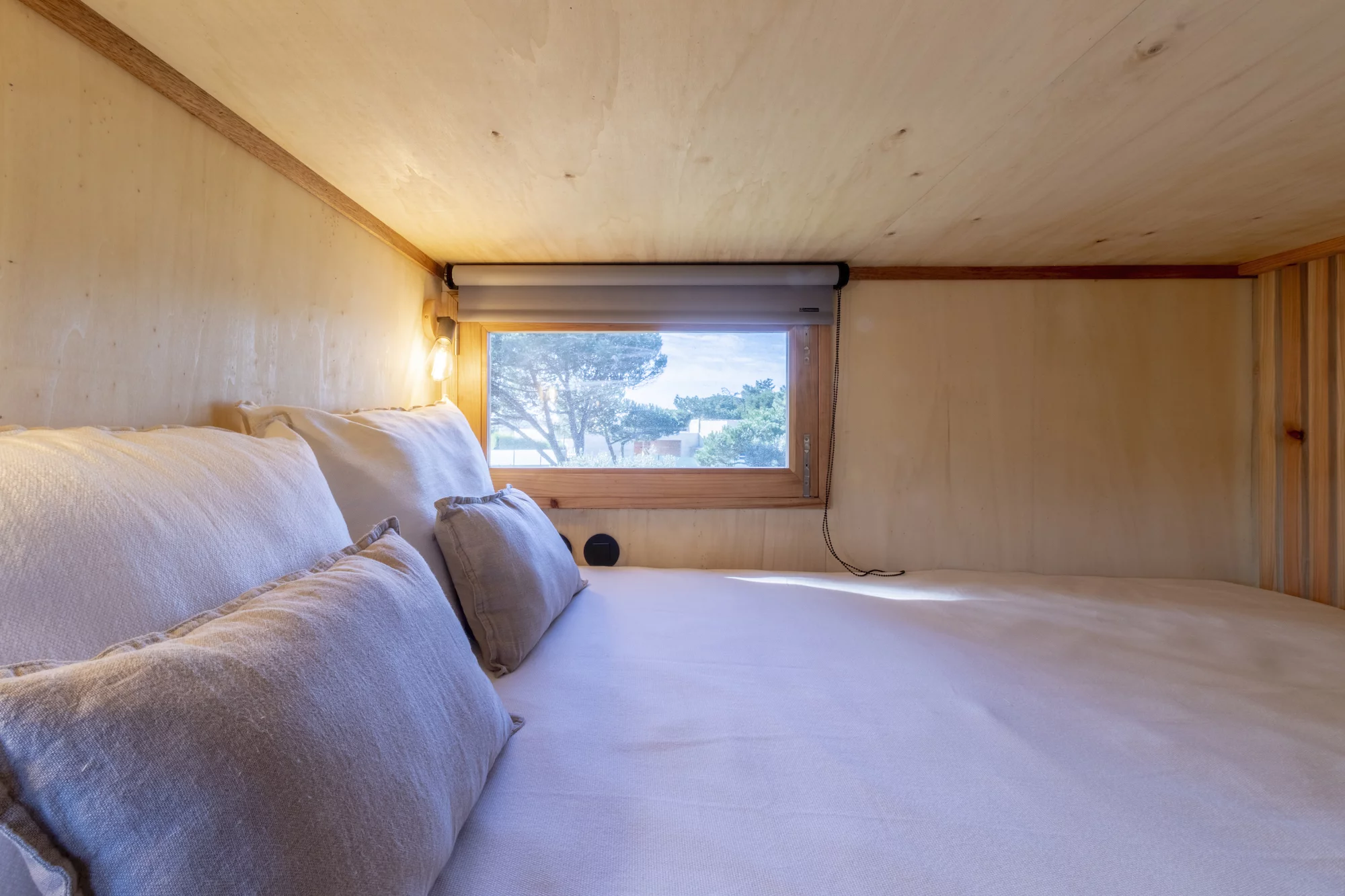 The Adraga's bedroom is a typical tiny house-style loft with a low ceiling