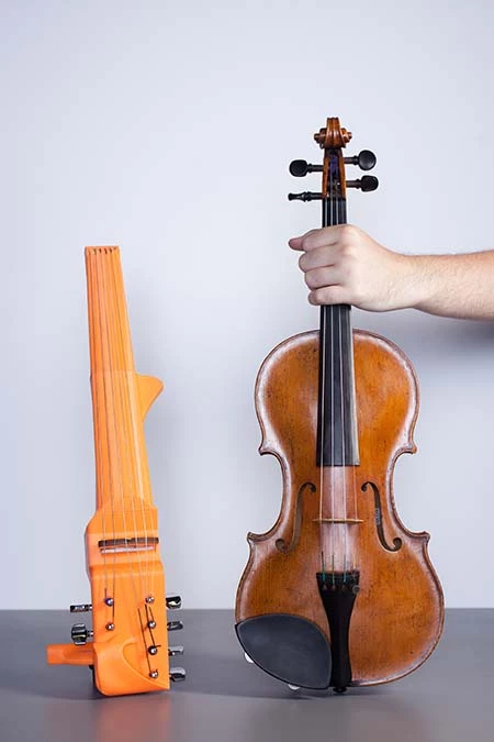 The 3D-printed frame of Sean Riley's custom 6-string violin sizes up against a classic 4-string model