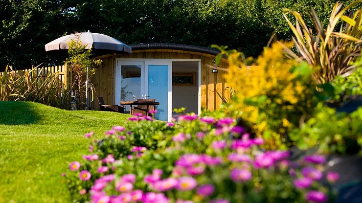 The pod design incorporates a curved green roof, that is in line with the surrounding clipped grass areas