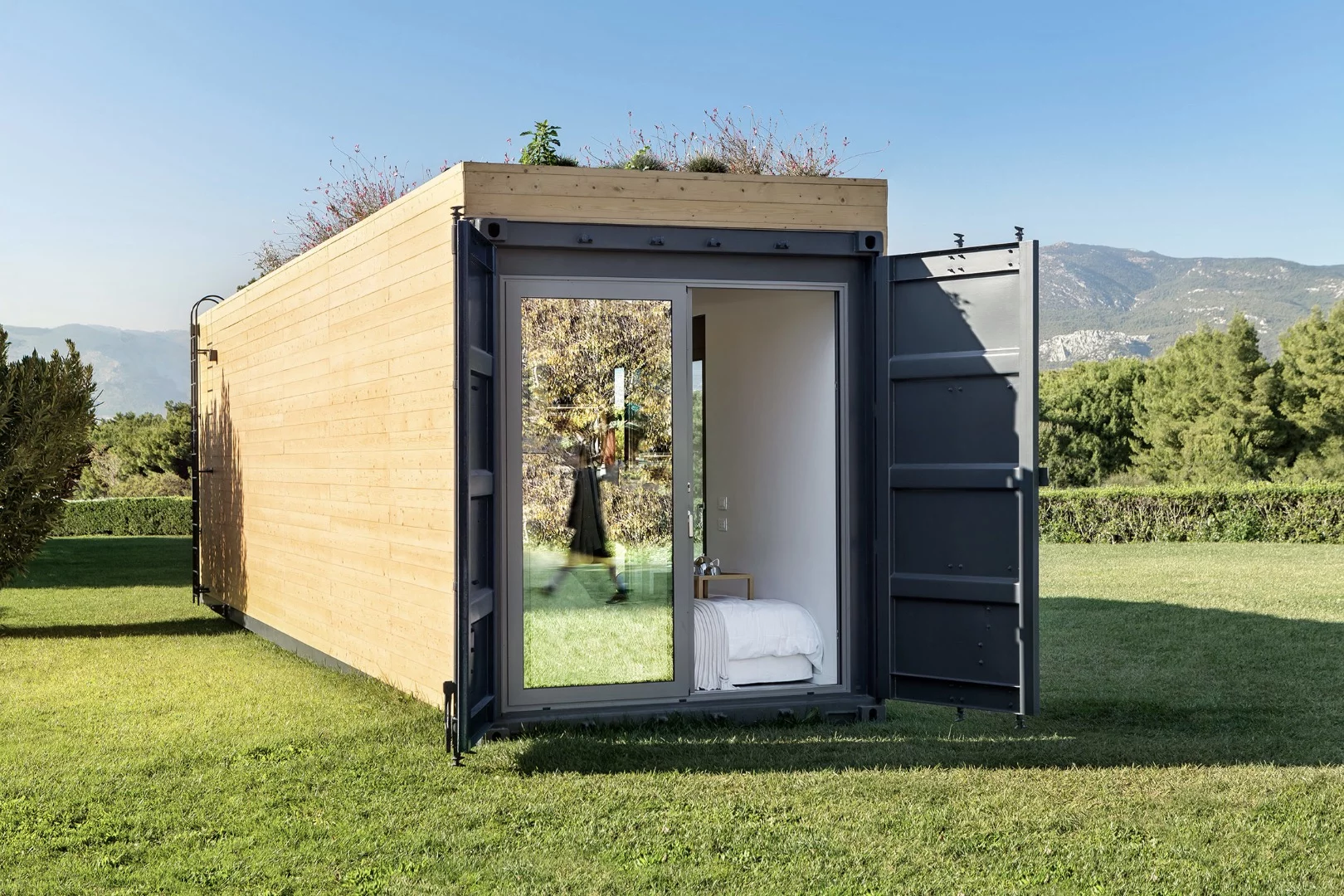 Cocoon Modules' shipping container house has a bedroom that opens to the outside