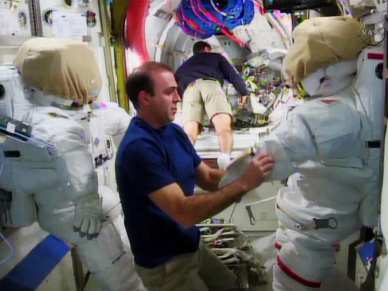 Rick Mastracchio checking the EMU suits (Photo: NASA)