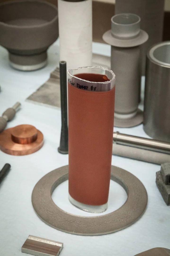 Cold spray technology has been used to put a metallic coating on the outside of this flexible plastic tube