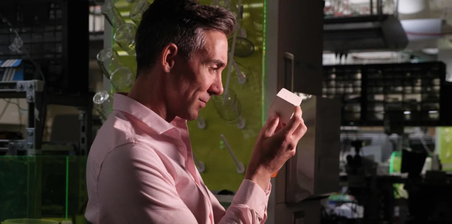 Material scientist Wil Srubar with a sample of concrete made using biogenic limestone