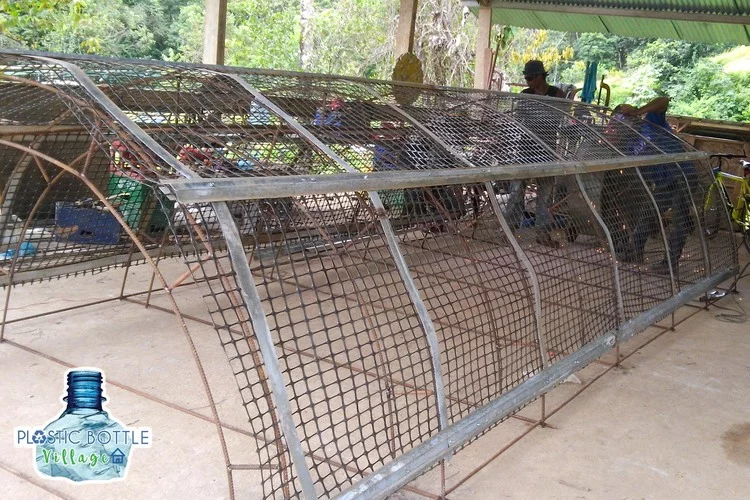 Each home is constructed by first building steel rebar panels and metal mesh to create a cage to hold the PET bottles