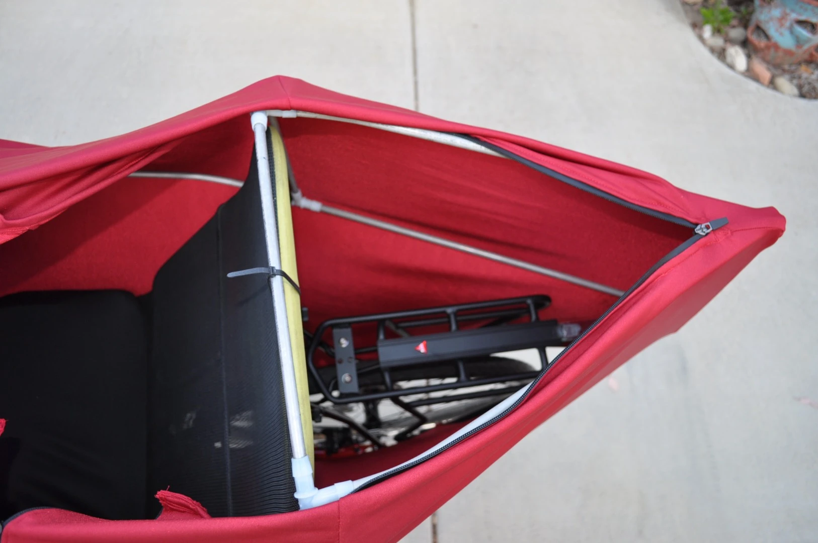 A zipper on the back of the Lightning F-22's shell allows for access to a nylon seat-back bag featuring two small pockets and a single large one, along with an Axiom aluminum alloy cargo rack