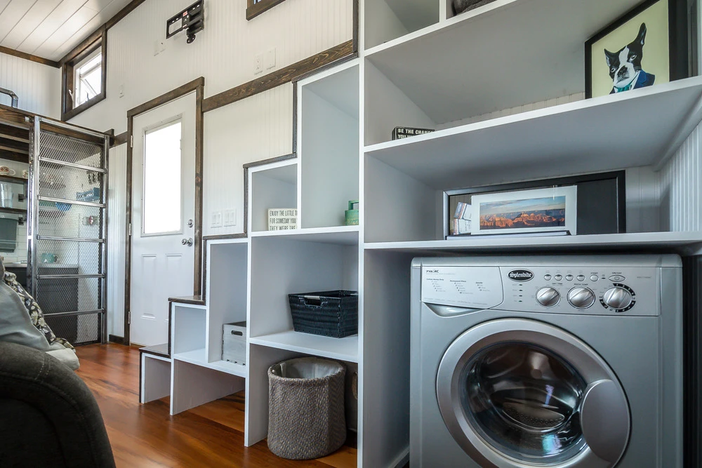 Storage stairs include a washer/dryer