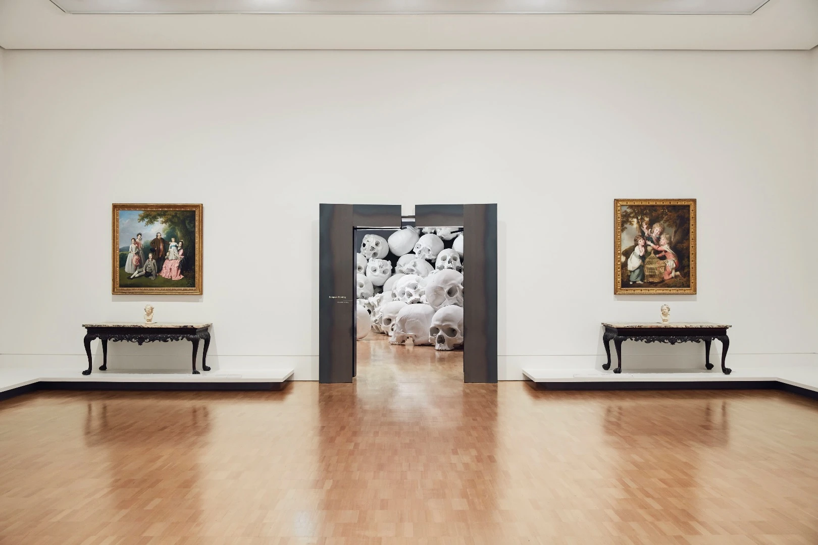 Ron Mueck's huge installation features 100 giant skulls strewn around the gallery's classic art collection