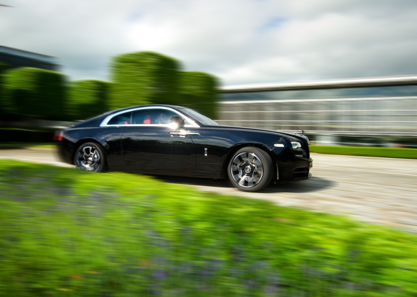 The Rolls-Royce Wraith on the move outside the brand's Goodwood factory