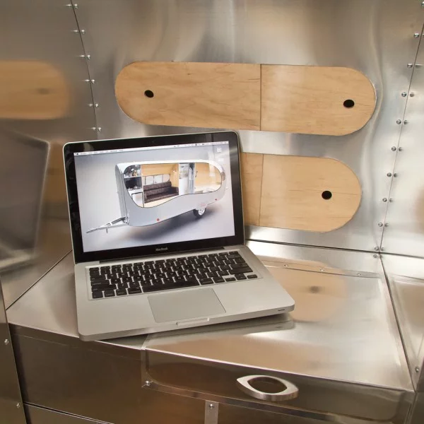 Next to the sofa is a charging station for laptops, tablets and cellular devices