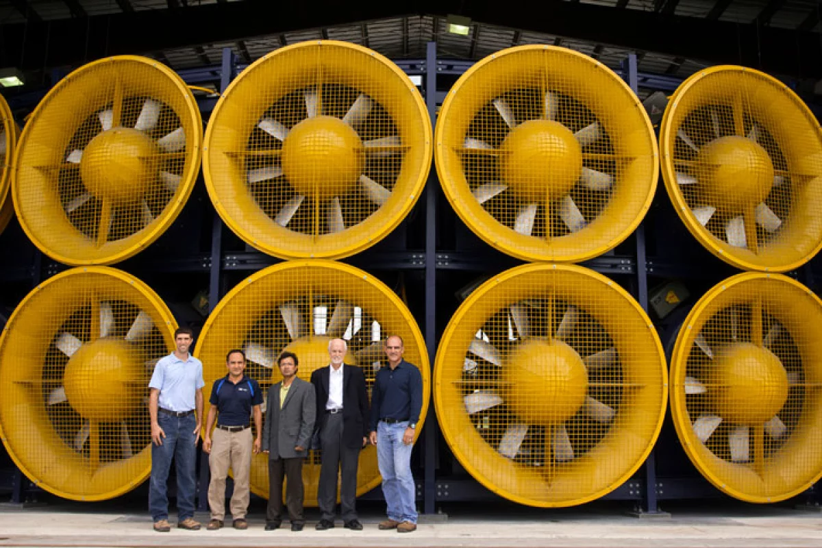 FIU's wind engineering team poses in front of the Wall of Wind